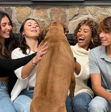 Sage Steele with her kids Nicholas Bailey, Quinn and Evan Bailey playing with their pet.